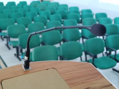 detail of podium with microphone in empty meeting room