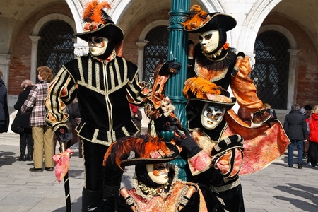 VENICE, ITALY - MARCH 4: Unidentified masked persons pose in front of Palazzo Ducale during the Venice Carnival on March 4, 2011 in Venice, Italy. The carnival is from February 26 - March 8, 2011.のeditorial素材