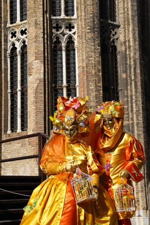 VENICE, ITALY - MARCH 5: Unidentified masked persons stand on small bridge during the Venice Carnival on March 5, 2011 in Venice, Italy. The carnival is from February 26 - March 8, 2011.のeditorial素材