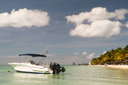 Small boat in front of a tropical beach, Mauritiusの写真素材