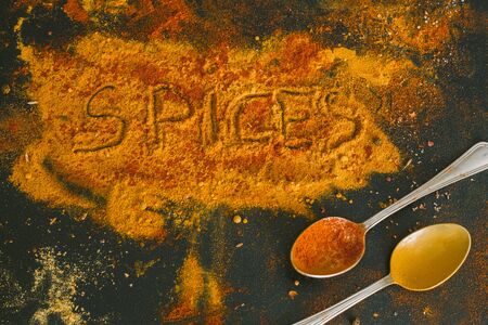 Various spices spoons on stone tableの写真素材