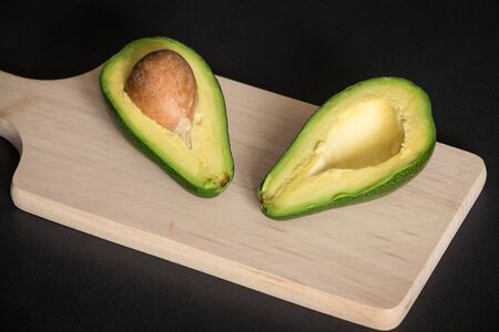 Sectioned avocado on a chopping board