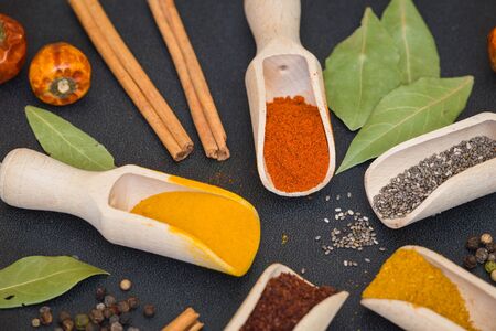 Various spices and herbs on the dark tableの写真素材