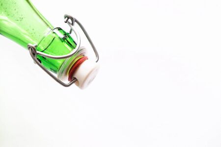 Old bottle with cap on a white backgroundの写真素材