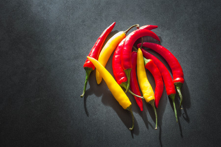 Hot paprika on a dark stone tableの写真素材