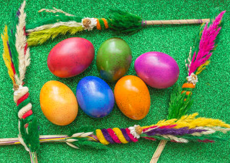 Colorful painted Easter eggs and decoration on the green backgroundの写真素材