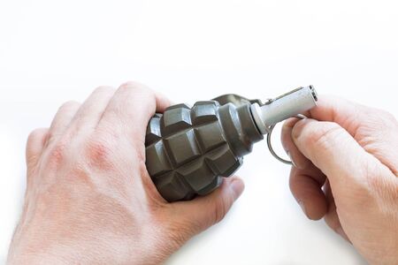Hand grenade in the small hands on the white backgroundの写真素材