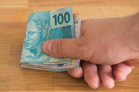 Big amount of brazilian money, reais, in hand, concept of successの写真素材
