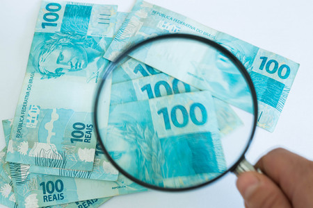 Brazilian currency, high nominal under the magnifierの写真素材