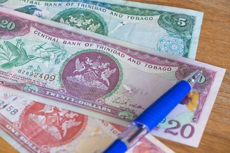 Trinidad and Tobago dollars with pen for calculationsの写真素材