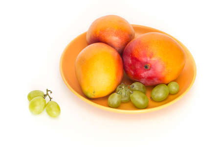 Fresh ripe mango, shown on a light backgroundの写真素材