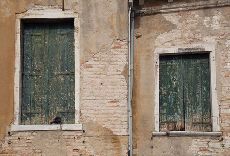 picturesque old wall and shuttersの写真素材