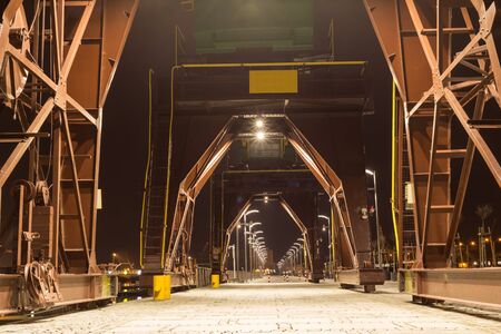 Industrial cranes by nightの写真素材