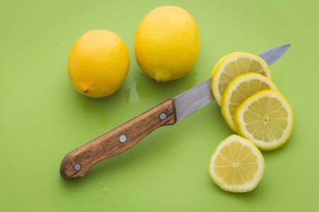 cut lemon on a green chopping board