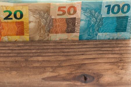 brazilian money all denominations on the wooden background with place for a text.の写真素材