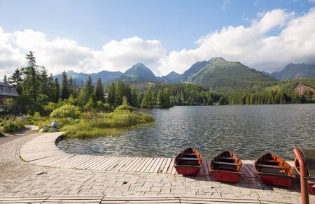Panorama mountain lake Strbske Pleso in the Tatra mountains. Summers colors and boat for swimmingの写真素材