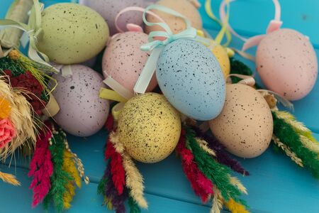 Easter eggs and decoration on wooden background