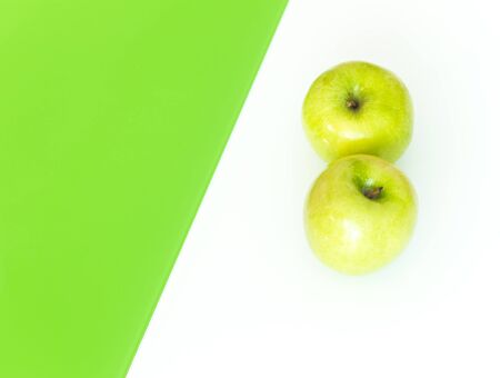 Green apples on the white-green glass background.の写真素材