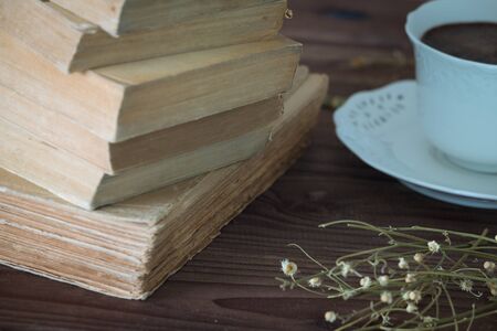 Old books along with a cup of coffe.の写真素材
