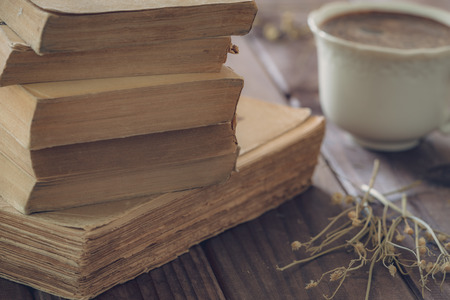 Old books along with a cup of coffeの写真素材