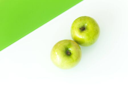 Green apples on the white-green glass background.の写真素材
