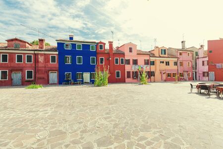 cozy courtyard with colorful cottage / Burano, Venice / The small yard with bright walls of housesの写真素材