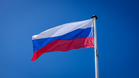 Russian flag fluttering against the blue sky