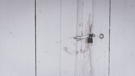 lock with a padlock. Old wooden door, vintage style backgroundの写真素材
