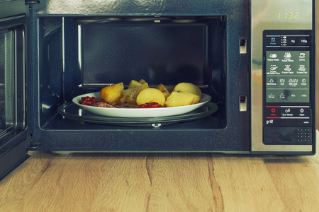 Microwave oven with a heated mealの写真素材