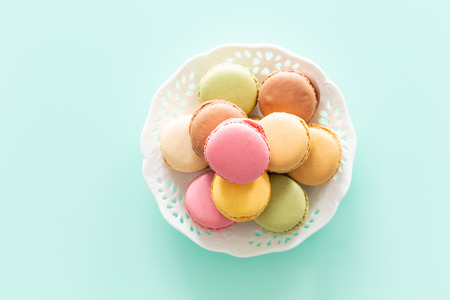macaroons cake in soft colors on the pastel green glass backgroundの写真素材