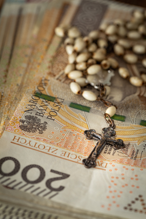 Catholic cross on a background of moneyの写真素材