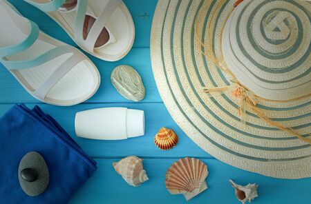holiday photo, summer hat, beach sandals, sunscreen, sun glasses, scallops and souvenir pebbles