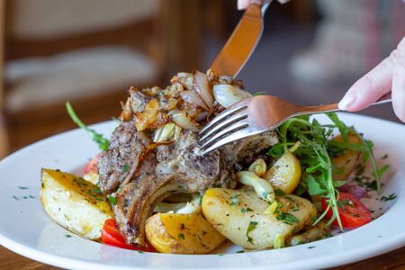 Roasted sheep meat with potatoes and beansの写真素材