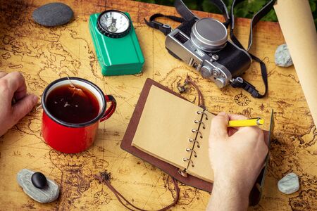 a map with a travel notebook and equipment in a retro style. Journey plan