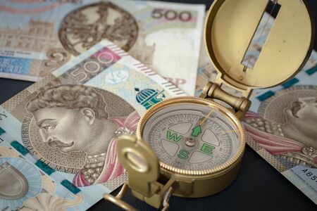 Polish money, 500 zloty with an old compass / business conceptの写真素材