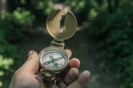 Man with a compass in his hand on the trailの写真素材
