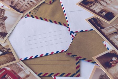 Stylish envelopes with space for an inscription and old cards from around the world. Travel and tourism conceptの写真素材