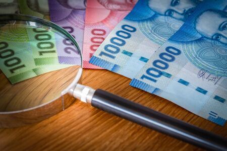 Chilean Peso, banknotes with magnifying glass
