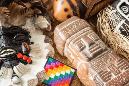 Indian sculptures from various parts of South America along with the flag of all Native Indiansの写真素材