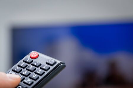 TV remote controls in hand