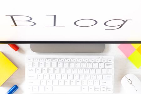 text displayed on the monitor, Blog. A desk with a computer keyboard and office accessories. The concept of running your own website for the internetの写真素材