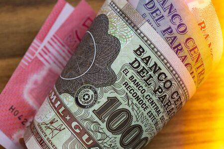 Rolled-up banknotes from Paraguay, a country from South America