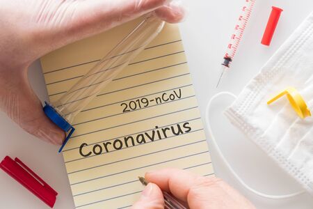 hand in a rubber glove holding a laboratory vial with the 2019-ConV virus. Concept, epidemiological...