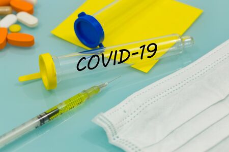 COVID-19 virus vial on a laboratory table. medicines and injections. Concept vaccine for the virusの写真素材