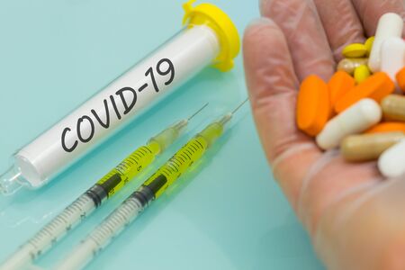 COVID-19 virus vial on a laboratory table. medicines and injections. Concept of treatment and vaccine for the virusの写真素材
