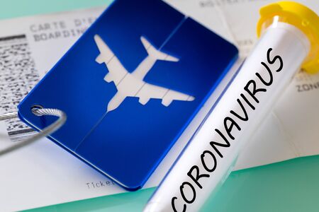 Coronavirus. Laboratory vial, boarding pass and luggage tag. Concept of Airline financial problems due to the virusの写真素材