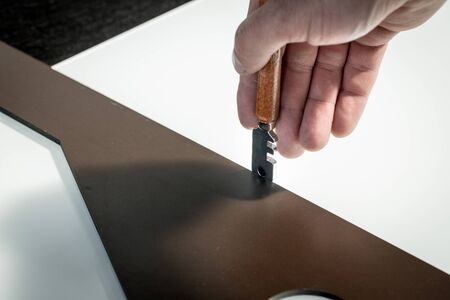 A worker cuts glass in a glass workshopの写真素材
