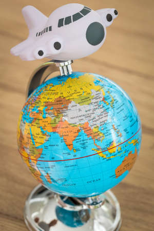 Globe and a toy plane, Concept for traveling around the world