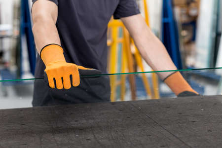 Glass factory, Glazier lifting that table glassの写真素材