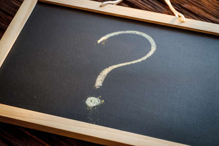 Question mark on a chalkboard. The concept of the unkown about the beginning of the new school yearの写真素材